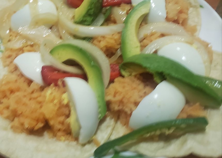 Tacos placeros served on a soft tortilla with breaded cutlet, avocado, egg and sliced chiles.